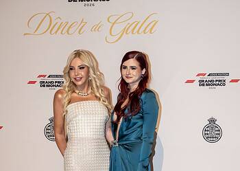 Lady Monika Bacardi and a woman at the Monaco Grand Prix 2026, dressed elegantly for the event, standing in front of a backdrop with event logos.