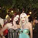 Lady Monika Bacardi and a guest at a glamorous outdoor event in Saint-Tropez, surrounded by elegant attendees and warm lighting, during a night of celebration.